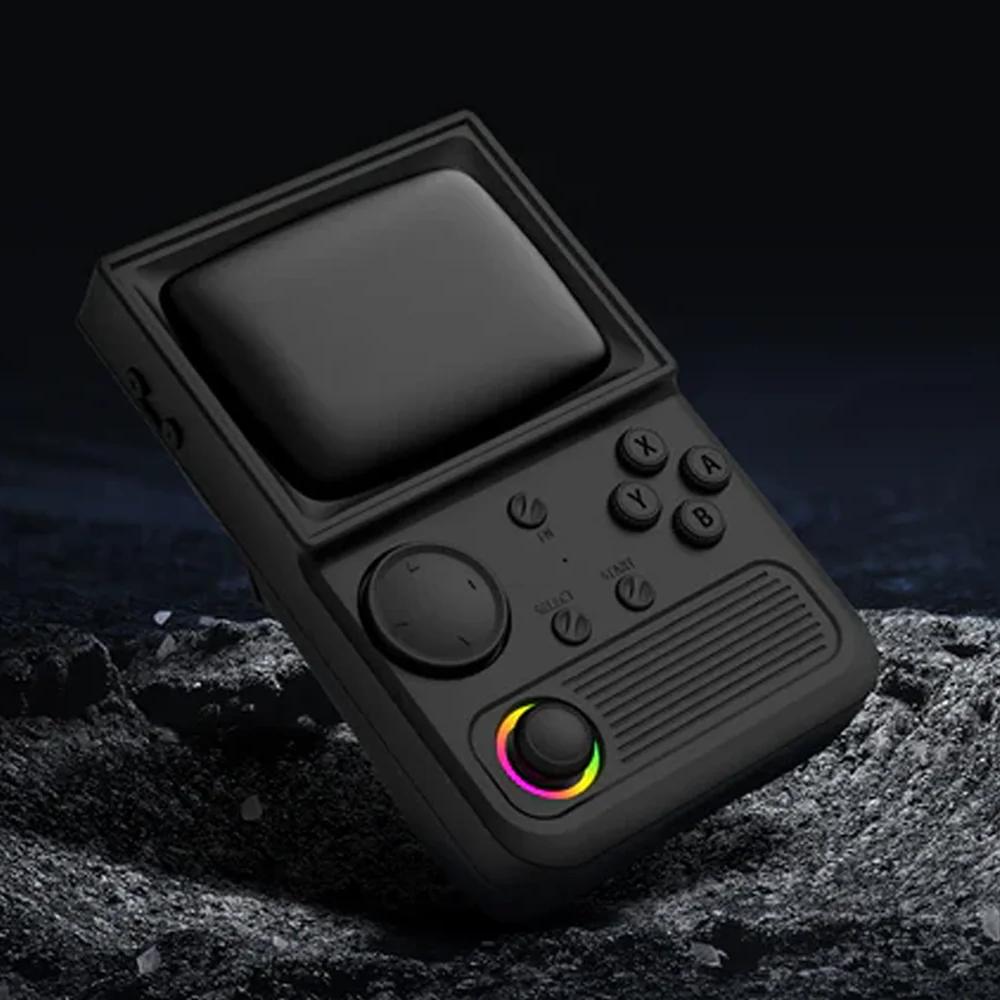 Black R36T retro gaming handheld console displayed on a rocky dark surface, featuring an RGB joystick and classic retro game controls.