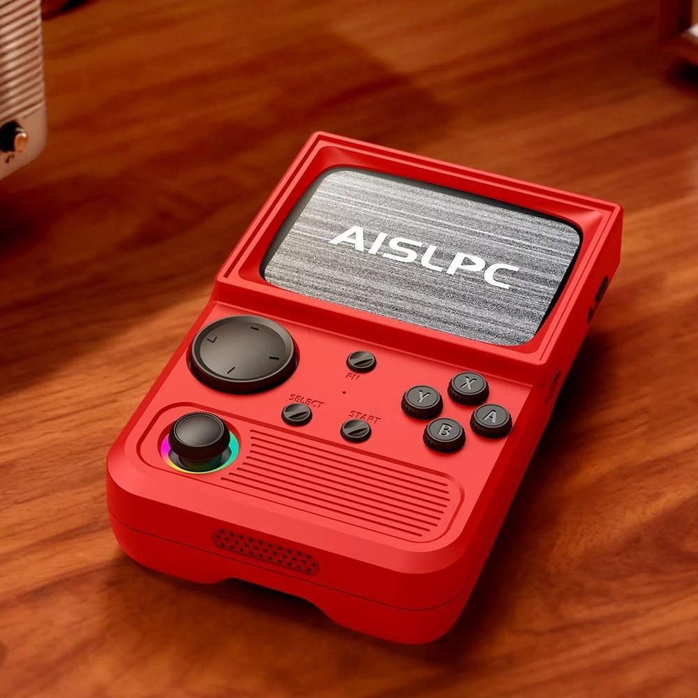 Red R36T retro gaming handheld console on a wooden desk, featuring an RGB joystick, black buttons, and AISLPC logo on the screen.